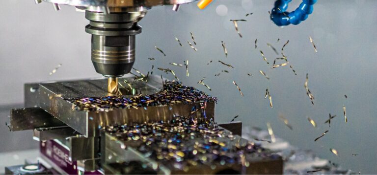 A close up view of a drill press milling out a piece of metal